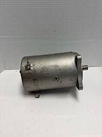 Side view of cylindrical electric motor showing maker plate and housing