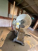 Makita LS1440 miter saw left-side profile showing blade guard, base and dust bag
