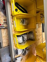 Multiple sealed nylon strap kits labeled SJK3 in yellow storage bins
