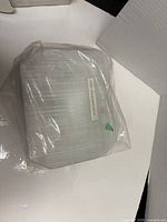 Sealed package containing grey strobe lens with label and connector visible