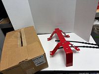 overall view of red bracket and cardboard box