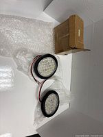 Pair of round LED trailer lights with wiring, bubble wrap and box