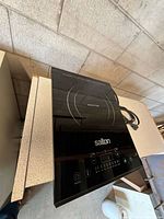 Top view showing Salton induction cooktop, control panel, power cord