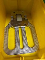 Footrest inside yellow bin showing step platform and mounting plate