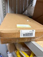 Sealed cardboard box with Fleetrite label showing part number FLTMIR4069