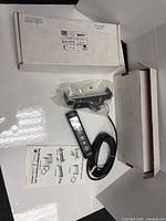 Full lot showing LED light, wiring, bracket in bag, manual, box