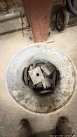 Bucket containing square steel washer plates and other scrap steel pieces