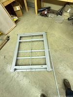 Full view of steel sliding storage frame on floor