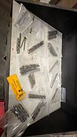 Top-down overview of drawer showing all resealable bags of drill bits