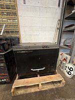 Front view of Ultra Pro Classic black steel tool chest on pallet