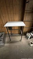 Front view of metal frame stand with laminate top