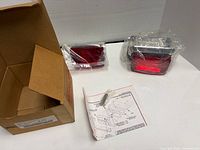 Entire kit with box, two red lens components, instructions and hardware