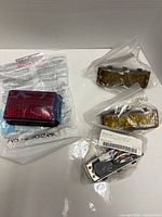 Overview of four Whelen 500 TIR lightheads in packaging (two amber, two red)