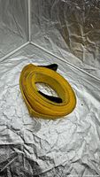 Rolled yellow tow strap in lightbox