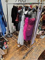 Full view of chrome garment rack loaded with clothing