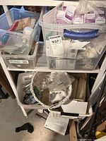 Shelf with multiple bins containing assorted bulbs, hardware and wicker basket