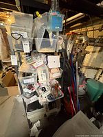 shelving unit with multiple clear bins containing assorted office and craft supplies