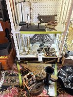 Overview of lot on and in front of shelving showing multiple brass, cast iron and wood hardware pieces