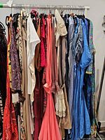 Rack with multiple dresses and tops in assorted colors and fabrics