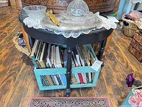 Full view of black distressed wooden side table with books stored below (books not included)