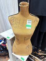 Front view of burlap Paris print mannequin torso showing graphics and neck fraying