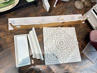 Wooden wall panel, shelf with hooks, additional shelf pieces visible