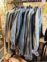 Rack of multiple faded blue denim jackets