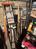 Overall view of two black metal display racks among other items