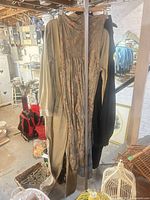Full view showing metal rack with clothes hanging to illustrate size and structure