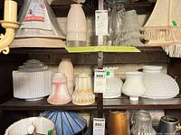 Shelf showing six assorted glass lamp shades