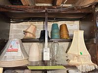 Shelf showing full assortment of fabric, plastic and glass shades