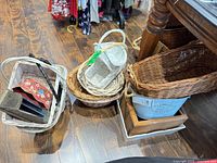 Group view of baskets, metal bucket, wooden box