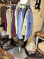 Full view of metal clothing rack with shirts (shirts excluded)