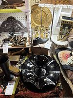 Group shot showing black glass centerpiece, wooden shoe last, brass candelabra, small wooden box, additional brass items