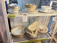 Assorted Noritake floral dinnerware on shelving