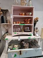 Overall lot showing pink cabinet with glassware and metal cake stand