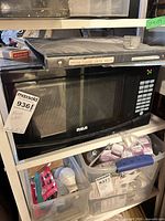Front view of RCA microwave on shelf