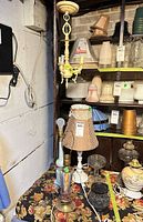 Chandelier and multiple table lamps arranged on floral cloth