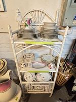 Front view of white bamboo-style etagere with dishes (not included)