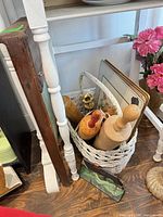 All items grouped: washboard, basket with three rolling pins, candle holder, decorative tray, cast iron house door stop