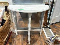 Front view of demi-lune table showing overall form and finish