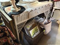 Full view of white wicker desk with items around it