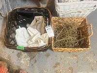 Two wicker baskets; canvas tote, purses and gold wire star ornaments visible