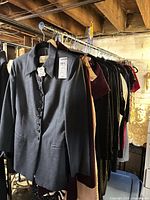 Rack of assorted women’s garments headed by grey blazer
