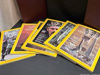 Group of six loose National Geographic magazines spread out showing covers