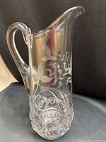 Full view of pressed glass tankard showing floral etch and handle