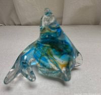 Front angled view of blue teal glass seal paperweight