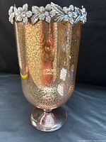 Full view of footed pink mercury glass votive holder