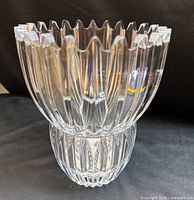Front view of clear ribbed lead crystal vase showing scalloped rim and waist