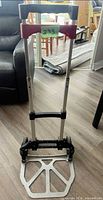 Full view of hand truck standing upright with handle extended